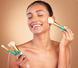 Image showing Makeup brushes, smile and woman with natural beauty, wellness and happiness from cosmetics. Facial skin glow, happy and cosmetic artist brush of a young female model with self care in a studio