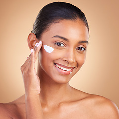 Image showing Skincare, sunscreen and portrait of a happy woman with cosmetic and spa cream. Isolated, studio background and young model with a smile from face cleaning, cosmetics and dermatology facial product