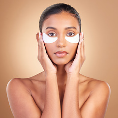 Image showing Skincare, eye patch and beauty with portrait of Indian woman for facial, spa treatment and glow. Self care, cosmetics and hydration with female model on brown background for mask, product and youth