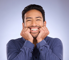 Image showing Portrait, excited and Asian man with success, smile and guy with news against grey studio background. Happy, Japan and male touching face, celebration and cheerful with joy, announcement or life goal