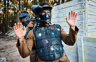 Image showing Man, paintball and hostage with gun in sports game, intense match or body shield in the outdoor forest. Male soldier in extreme sport holding enemy player for cover while aiming down sights at target