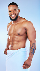 Image showing Black man, bodybuilder and towel in studio portrait with smile, wellness or start to morning by blue background. Youth african guy, body and skincare with happiness, health and self care by backdrop