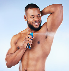 Image showing Deodorant, spray and black man with smile in studio for beauty, grooming and body hygiene on blue background. Skincare, health and male spraying aerosol, fragrance and scent product for underarm