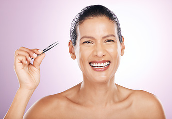 Image showing Beauty, portrait and woman with tweezers in studio for mature facial hair removal routine. Self care, grooming and female model plucking her eyebrows for face epilation treatment by purple background