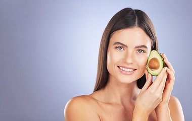 Image showing Space, happy and a portrait of a woman with an avocado isolated on a blue background in a studio. Skincare, hair care and a girl with food for a diet, nutrition and glow of skin with mockup