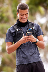 Image showing Fitness, man and phone with smile for social media, communication or chatting in nature. Happy active male smiling on mobile smartphone for chat, texting or networking after outdoor workout exercise