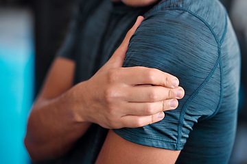 Image showing Hand, shoulder and injury with a sports man holding a joint in pain while training in a gym for health. Fitness, accident or anatomy with a male athlete suffering from an injured body during exercise