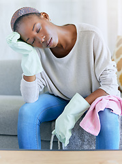 Image showing Housework, exhausted and woman cleaner on a sofa taking a break while spring cleaning a home. Tired, stress and African female maid or housewife sleeping in the living room after working at a home.