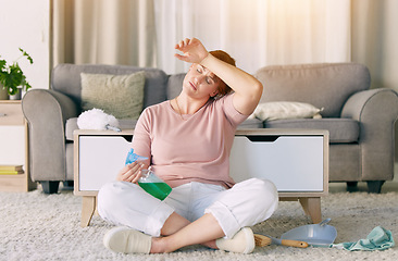 Image showing Tired woman, housekeeping and detergent from spring cleaning services in living room on floor at home. Exhausted female maid or cleaner in burnout, stress or fatigue for routine maintenance in lounge