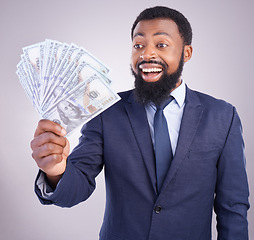 Image showing Wow, cash and investment with a business black man in studio on a gray background as a lottery winner. Money, accounting and finance with a male employee holding dollar bills for the economy