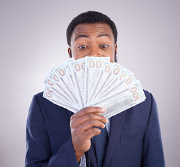 Image showing Eyes, cash and investment with a business black man in studio on a gray background as a lottery winner. Money, accounting and finance with a male employee holding dollar bills for the economy