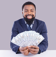 Image showing Portrait, cash and investment with a business black man in studio on a gray background as a lottery winner. Money, accounting and finance with a male employee holding dollar bills for the economy