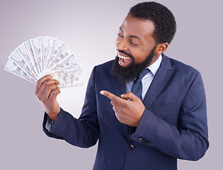 Image showing Wow, money and investment with a business black man in studio on a gray background as a lottery winner. Cash, accounting and finance with a male employee pointing to dollar bills for the economy