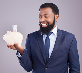 Image showing Black man, piggy bank and smile for financial investment or savings against a white studio background. Happy African American businessman smiling holding cash or money pot for investing in finance