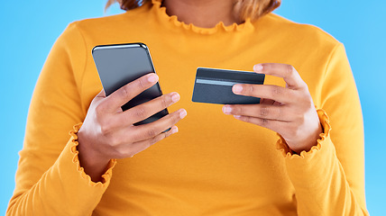 Image showing Woman hands, credit card and phone in studio for online shopping, digital fintech payment and customer money. Closeup female, ecommerce and mobile banking for finance, cash economy or sales promotion