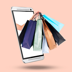 Image showing Hands, phone and screen on mockup with shopping bags for purchase, advertising or marketing against a studio background. Hand of shopper with gifts on mobile smartphone display for online ecommerce