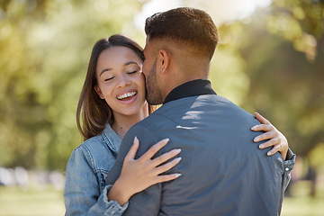 Image showing Couple, outdoor and kiss on cheek with a smile for love, care and happiness together in summer. Young man and woman at nature park for affection or hug on happy and romantic date or vacation to relax