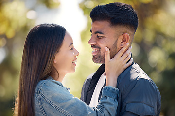 Image showing Couple, outdoor and smile for love, care and happiness together in summer. Young woman with hand on face of a man at nature park for affection or trust on happy and romantic date or vacation to relax