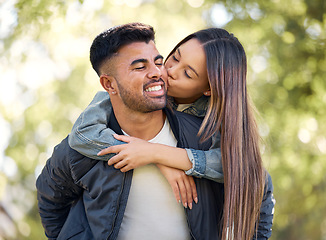 Image showing Couple, outdoor and piggyback with kiss for love, care and happiness together in summer. Young man and woman at nature park for affection, play or game on happy and romantic date or vacation to relax