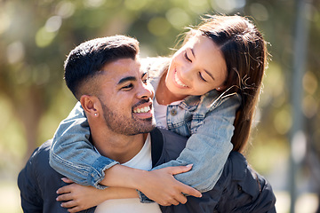 Image showing Couple, outdoor and piggy back with a smile for love, care and happiness together in summer. Young man and woman at nature park for affection or hug on a happy and romantic date or vacation to relax