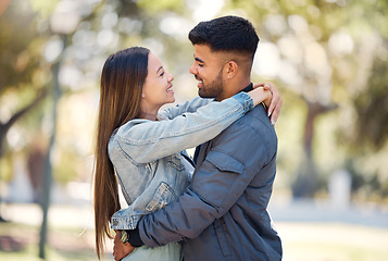 Image showing Couple, hug and outdoor with a smile for love, care and happiness together in summer. Young man and woman at nature park for affection or trust on a happy and romantic date or vacation to relax