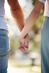 Image showing Back of couple holding hands in park for love, date or marriage commitment together in garden. Closeup hand of man, woman and walking in nature, loyalty and care for partner, trust or support outdoor