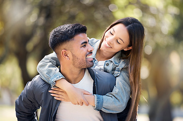 Image showing Couple, smile and outdoor on piggyback for love, care and happiness together in summer. Young man and woman at nature park for a moment on a happy and romantic date or vacation to relax