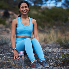 Image showing Woman, portrait or fitness break in nature training, exercise or workout for cardio, wellness or athlete sports. Smile, happy or relax runner sitting in remote park for outdoor marathon running