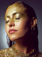 Image showing Gold, woman luxury and beauty sparkle of a female with makeup and cosmetic glitter. Creative fashion, cosmetics and face glow of a young person with eyeshadow shimmer and golden sparkles in studio