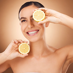 Image showing Skincare, lemon and woman face cleaning of a young person with happiness in a studio. Happy, smile and dermatology of a female with cosmetics, spa aesthetic and healthy fruit for wellness facial