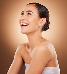 Image showing Studio face, laugh and beauty woman with luxury facial cosmetics, natural makeup and skincare glow. Dermatology healthcare satisfaction, spa salon person or aesthetic female model on brown background