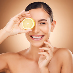 Image showing Beauty, health portrait or happy woman with lemon for citrus fruit detox, healthcare or natural facial skincare routine. Vitamin c food product, studio face or female nutritionist on brown background