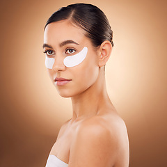 Image showing Skincare, face or woman with eye patch for studio dermatology, cosmetic healthcare or beauty treatment. Spa care, facial collagen product or female model with hyaluronic acid mask on brown background