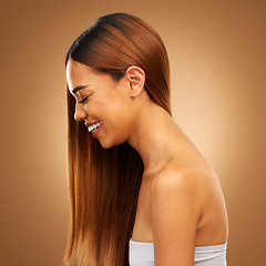 Image showing Haircare, beauty and woman of laughing in studio for growth and color shine or healthy texture. Aesthetic female happy face for hair, natural skincare and hairdresser or salon on brown background