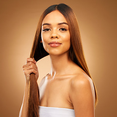 Image showing Haircare, hand and strength, portrait of woman in studio holding strong hair with texture and salon shine. Happy model, mockup and beauty, straight hairstyle with keratin product on brown background.