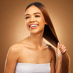 Image showing Haircare, smile and woman with strong straight hair in hand and studio space with texture and salon shine. Beauty model, healthy hairstyle and natural keratin product promotion on brown background.