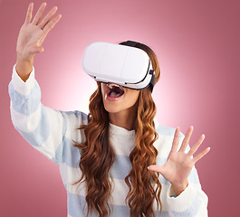 Image showing Virtual reality, metaverse and 3D with a woman using a headset to access the virtual world of gaming. AI, innovation and VR with a female gamer in studio on a pink background using future technology