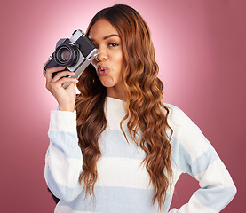 Image showing Portrait, photography and happy woman in studio with camera, pose and gen z retro aesthetic on pink background. Face, photographer and girl posing for picture, photo or photograph on isolated mockup