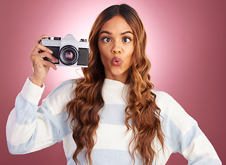 Image showing Photography, woman with camera and comic face on studio background, creative travel or fashion shoot. Art, professional lifestyle and hispanic photographer with hobby or career in photos or pictures.