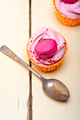 Image showing pink berry cream cupcake with macaroon on top