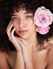 Image showing Flowers, makeup and portrait of woman for beauty, cosmetics and haircare for wellness, glamour and glow. Salon, luxury spa and serious face of girl for natural, skincare or facial treatment in studio