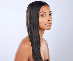 Image showing Indian woman, hair care or beauty in studio portrait for strong, healthy natural shine or wellness. Face of glowing young girl model, self love or salon cosmetics in grooming on white background