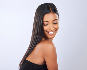 Image showing Happy, hair care or Indian woman in studio for beauty, healthy natural shine, growth or wellness. Smile of glowing young girl model, self love or salon spa cosmetics in grooming on white background