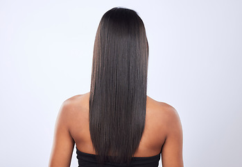 Image showing Indian woman, hair care or back view in studio for keratin, healthy natural shine or wellness. Girl model, luxury beauty salon or self care cosmetics in grooming on white background for growth