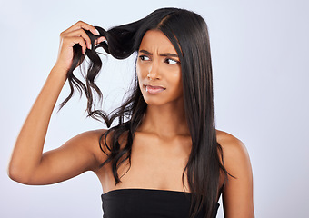 Image showing Indian woman, problem or bad hair care in studio for unhealthy damage, trouble or frizzy texture. Sad, upset or frustrated young girl model in self care cosmetics in grooming on white background