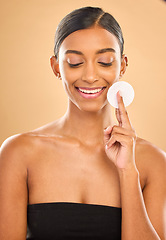 Image showing Beauty, skin and face cotton of woman in studio for cosmetics, dermatology or makeup. Aesthetic female .hand with product for self care, natural makeup and facial shine results on a brown background