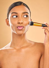 Image showing Indian woman, beauty and brush for makeup with cosmetic tools, skin glow and kiss face on studio background. Happy female, thinking and cosmetology, apply foundation or powder with self care