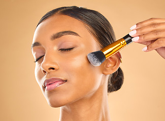 Image showing Indian woman, face and makeup, brush and beauty with cosmetic tools and eyes closed on studio background. Skin glow, cosmetology and apply foundation or powder, cosmetics and peace with self care