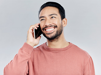 Image showing Happy, young asian man and phone call in studio for communication, networking and white background. Student male model, smartphone and excited smile for chat, listening and talking with happiness