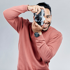 Image showing Man with camera, photography in portrait with smile, taking picture with art and smile isolated on studio background. Photographer, happiness and creativity with vintage technology with creative male